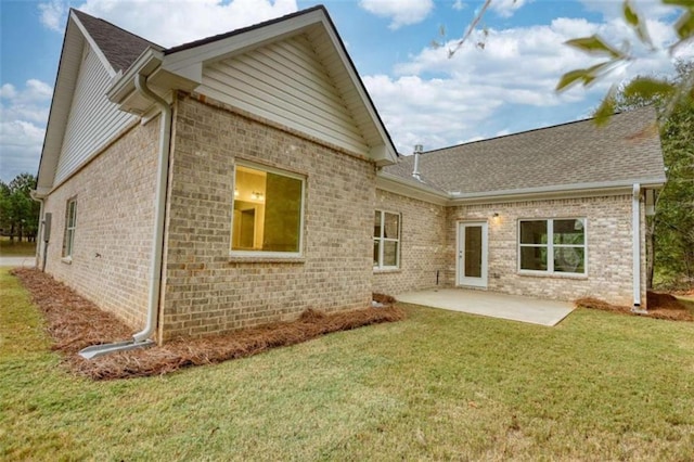 960 Park Place St, Social Circle, GA 30025 - rear view of house featuring brick siding, a patio, a lawn, and a shingled roof
