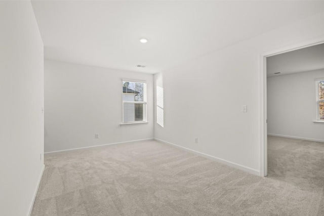 unfurnished room with light colored carpet