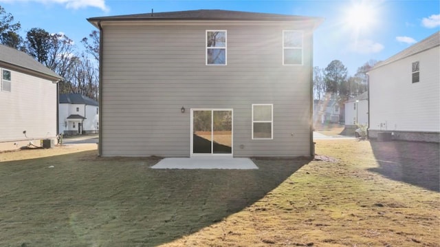 back of house featuring a patio area and a yard