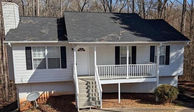 1668 Independence Dr, Douglasville, GA 30134 - view of front facade with covered porch, a chimney, and stairs