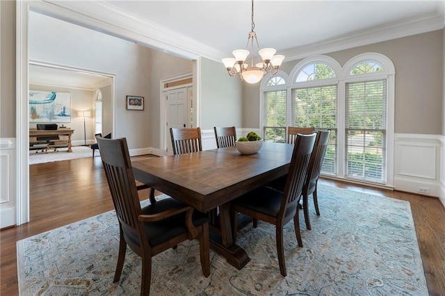 10135 High Falls Pointe Pointe, Johns Creek, GA 30022 - dining space with crown molding, plenty of natural light, a chandelier, wood finished floors, and a wainscoted wall