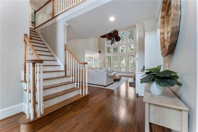 10135 High Falls Pointe Pointe, Johns Creek, GA 30022 - stairway featuring a towering ceiling, wood finished floors, baseboards, and ceiling fan