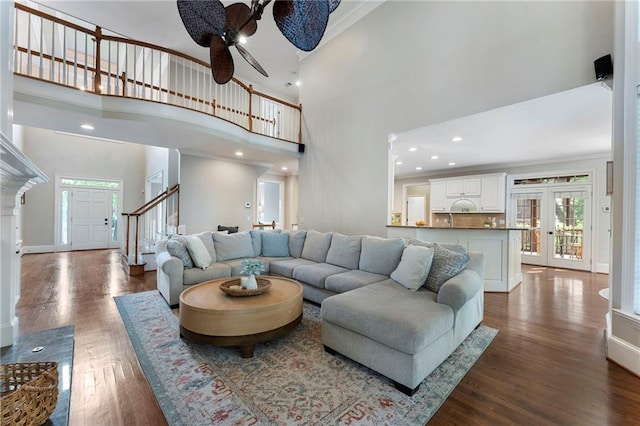 10135 High Falls Pointe Pointe, Johns Creek, GA 30022 - living room with a towering ceiling, dark wood-style floors, ceiling fan, stairs, and baseboards