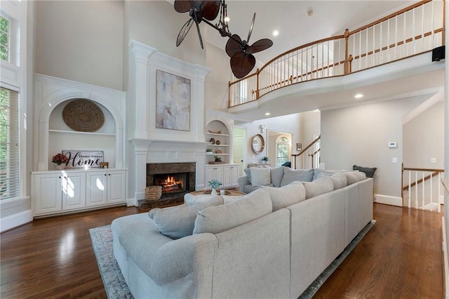10135 High Falls Pointe Pointe, Johns Creek, GA 30022 - living area with a high ceiling, plenty of natural light, stairs, a fireplace, and built in features