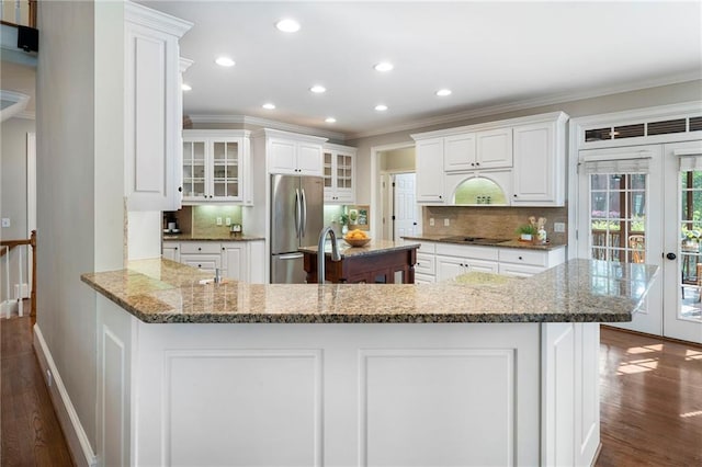 10135 High Falls Pointe Pointe, Johns Creek, GA 30022 - kitchen with freestanding refrigerator, dark wood-style flooring, black electric stovetop, crown molding, and decorative backsplash