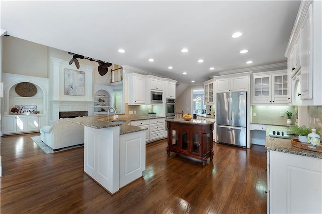 10135 High Falls Pointe Pointe, Johns Creek, GA 30022 - kitchen with stainless steel appliances, a sink, recessed lighting, glass insert cabinets, and stone counters