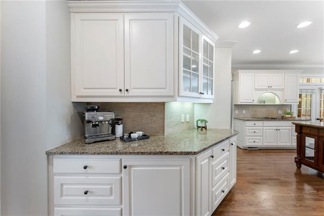 10135 High Falls Pointe Pointe, Johns Creek, GA 30022 - kitchen with tasteful backsplash, white cabinetry, black electric stovetop, glass insert cabinets, and dark wood-style floors