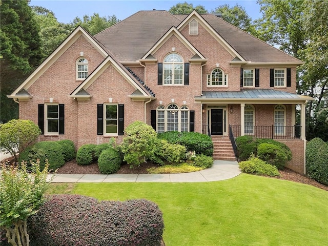 10135 High Falls Pointe Pointe, Johns Creek, GA 30022 - georgian-style home featuring brick siding, a front yard, covered porch, and stairs