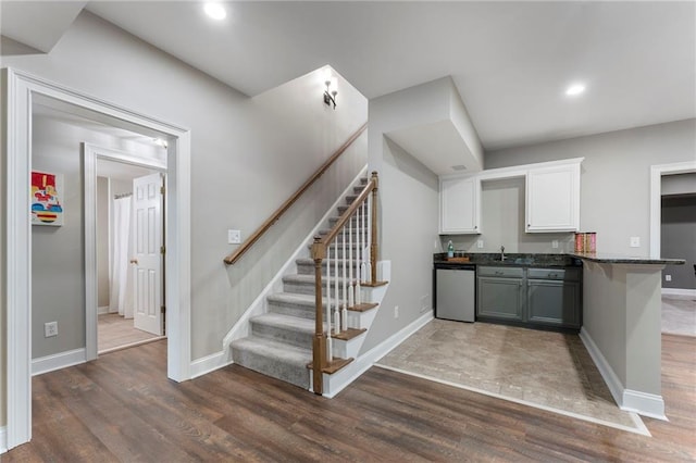 10135 High Falls Pointe Pointe, Johns Creek, GA 30022 - kitchen featuring stainless steel dishwasher, dark wood finished floors, white cabinets, a sink, and dark countertops