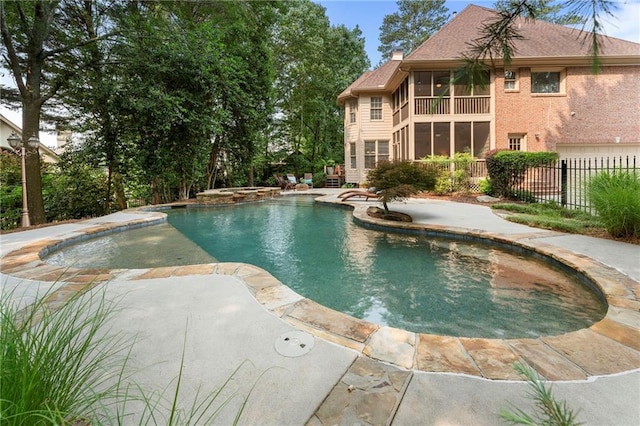 10135 High Falls Pointe Pointe, Johns Creek, GA 30022 - view of pool with a pool with connected hot tub, a sunroom, and a patio area