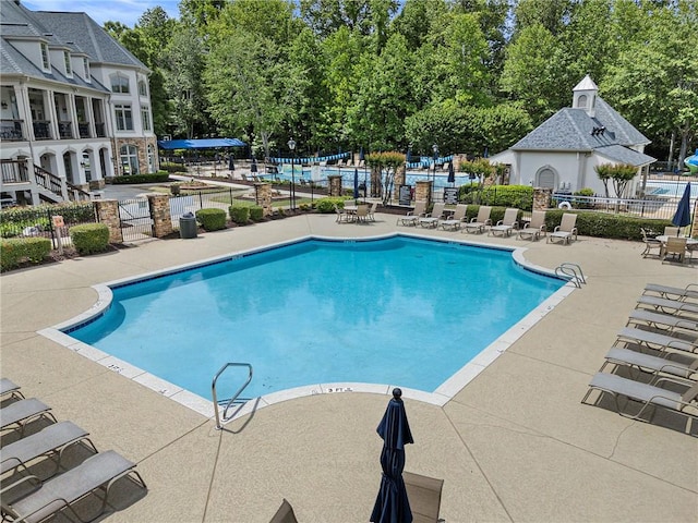 10135 High Falls Pointe Pointe, Johns Creek, GA 30022 - community pool featuring a patio area and view of scattered trees