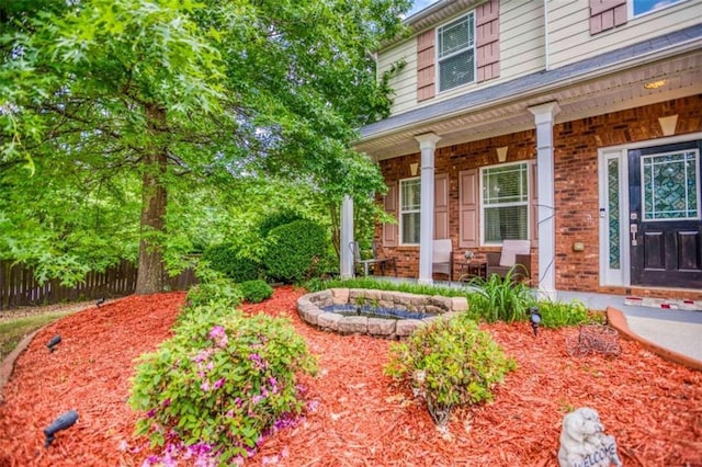 view of yard with a porch and fence