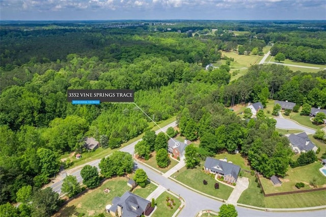 view of property location with a heavily wooded area