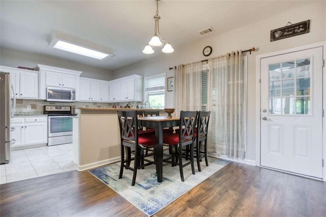 dining space featuring light wood-type flooring