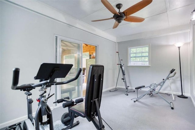 exercise area with baseboards, ceiling fan, and carpet floors