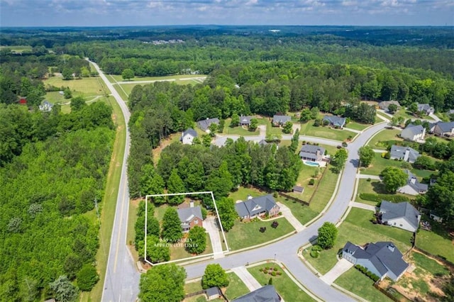 aerial view of residential area featuring a forest and property boundaries highlighted