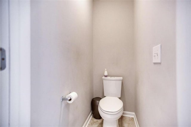 bathroom featuring toilet and baseboards