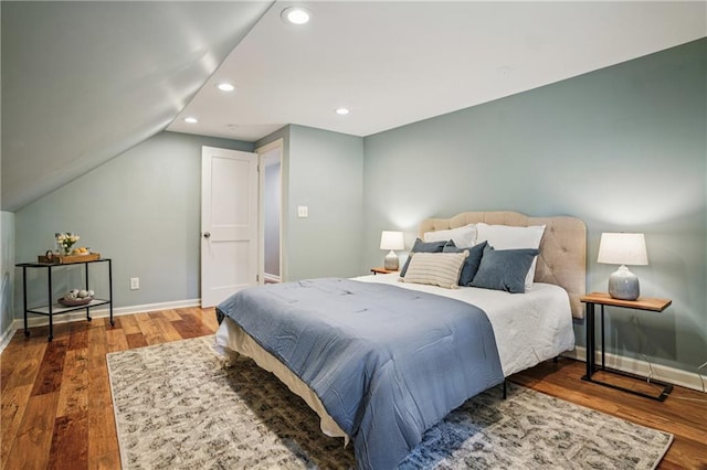 615 Sycamore Dr, Decatur, GA 30030 - bedroom featuring wood finished floors, recessed lighting, baseboards, and lofted ceiling
