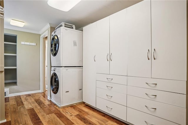615 Sycamore Dr, Decatur, GA 30030 - washroom featuring stacked washer / drying machine, light wood-style flooring, and ornamental molding