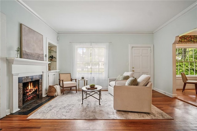 615 Sycamore Dr, Decatur, GA 30030 - living room featuring crown molding, wood finished floors, a fireplace, and baseboards