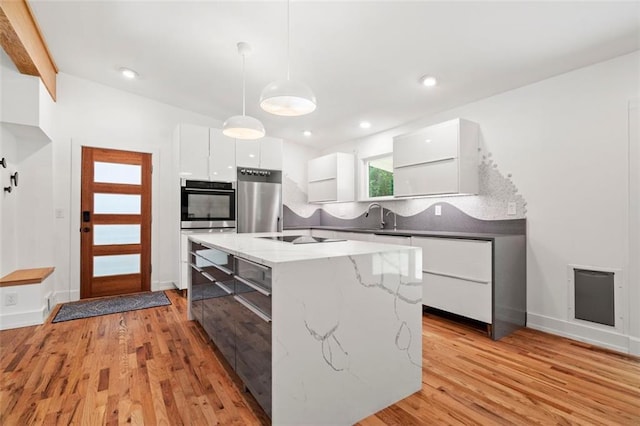 1492 Sagewood Cir, Stone Mountain, GA 30083 - kitchen with modern cabinets, fridge, stainless steel double oven, white cabinets, and decorative light fixtures