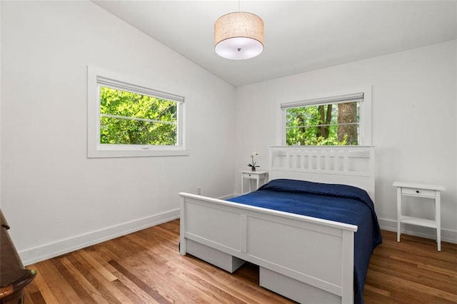 1492 Sagewood Cir, Stone Mountain, GA 30083 - bedroom featuring wood finished floors, baseboards, and lofted ceiling