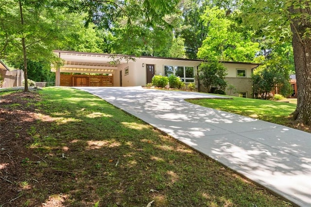 1492 Sagewood Cir, Stone Mountain, GA 30083 - view of front facade with driveway, stucco siding, a front yard, and a carport
