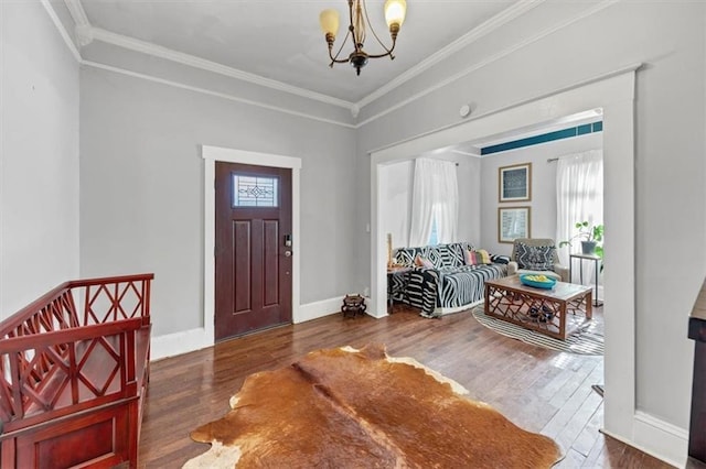 foyer featuring crown molding, dark wood-type flooring, and a chandelier