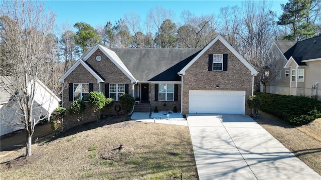 view of front of house featuring driveway, a garage, and brick siding