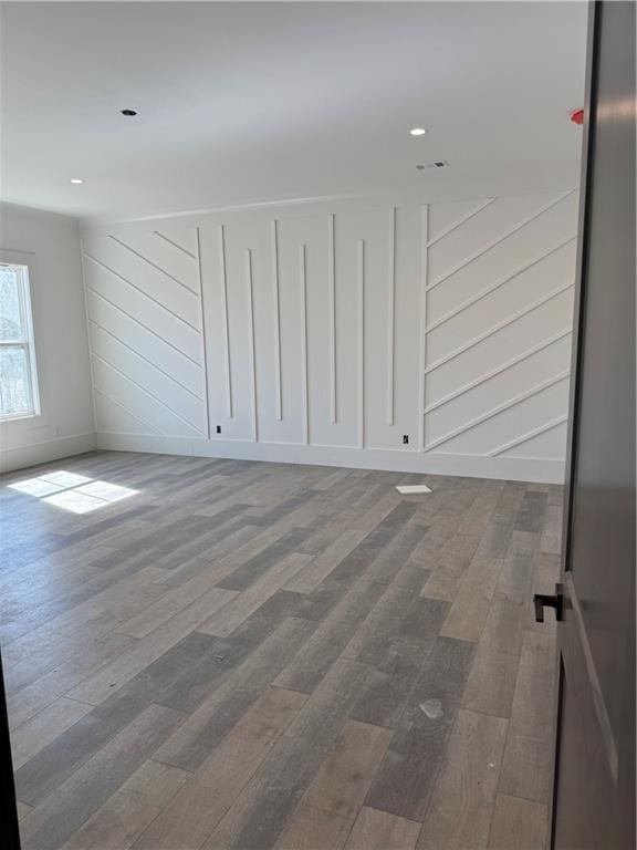 empty room featuring recessed lighting and wood finished floors