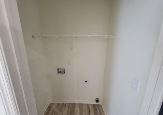 laundry area with washer hookup, electric dryer hookup, and light wood finished floors