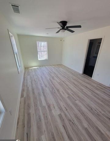 unfurnished room featuring visible vents, ceiling fan, and light wood finished floors