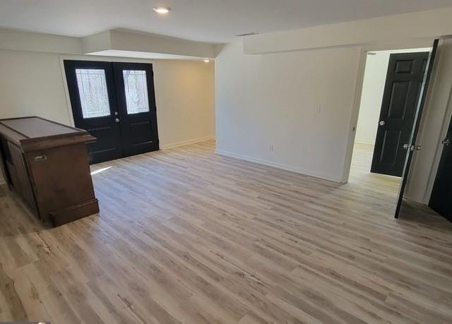 entrance foyer featuring recessed lighting, french doors, light wood-style flooring, and baseboards