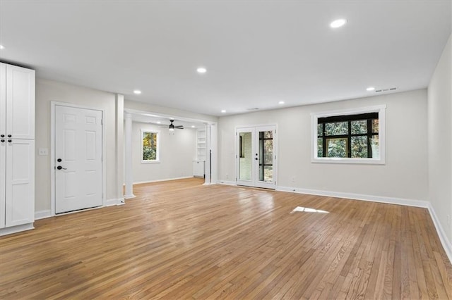 unfurnished living room with ceiling fan and light hardwood / wood-style floors