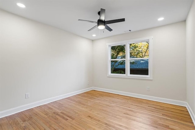 empty room with ceiling fan and light hardwood / wood-style flooring