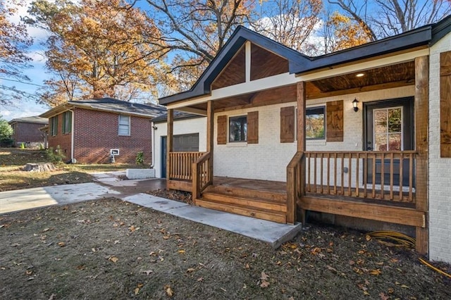 back of property featuring a porch