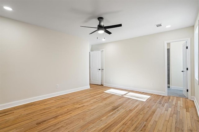 empty room featuring ceiling fan and light wood-type flooring