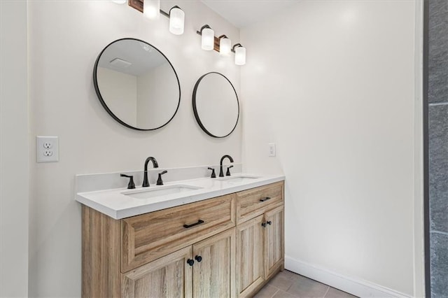 bathroom featuring tile patterned flooring and vanity