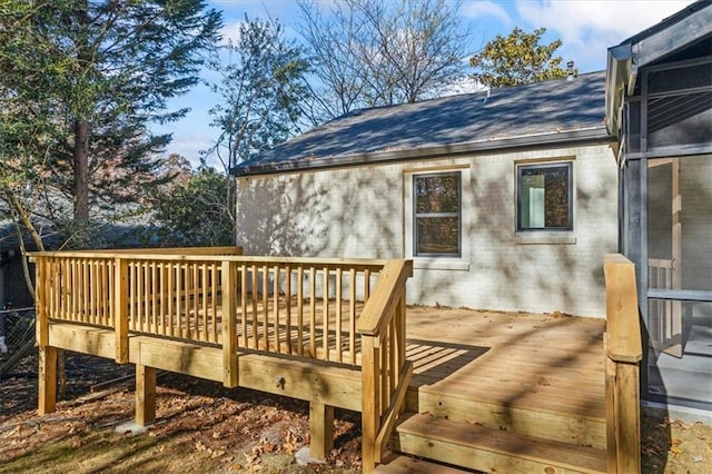 wooden deck with a sunroom