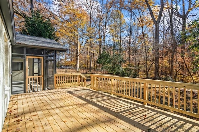 wooden deck with a sunroom