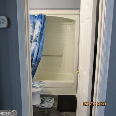 full bathroom featuring tile patterned floors, toilet, and shower / bath combo