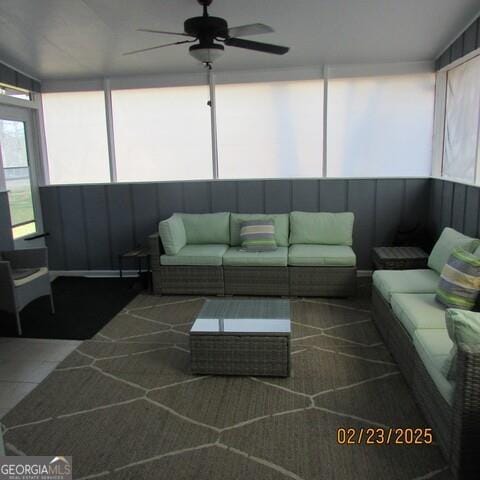 sunroom featuring ceiling fan