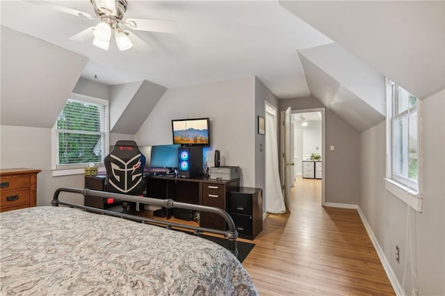 bedroom featuring baseboards, vaulted ceiling, a ceiling fan, and light wood-style floors