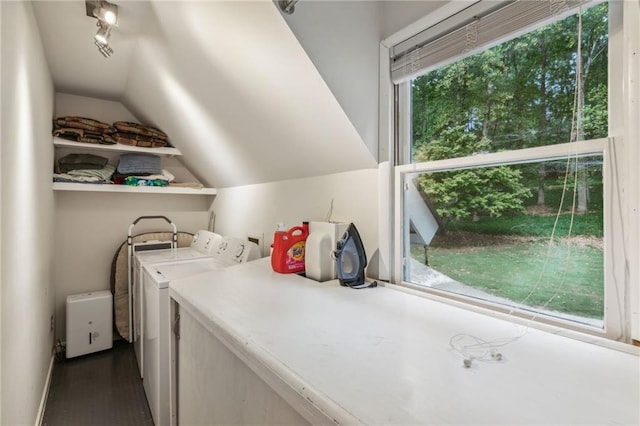 laundry area featuring laundry area, washing machine and clothes dryer, and rail lighting