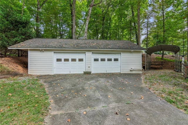 detached garage featuring fence