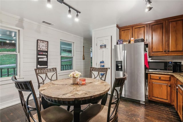 dining room with ornamental molding, dark wood-style flooring, and visible vents