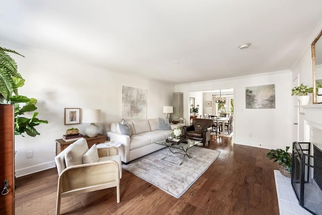 living room featuring dark wood-type flooring and a tile fireplace