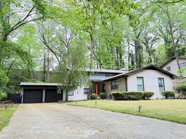 3629 Embry Cir, Atlanta, GA 30341 - view of front of house featuring a front lawn, brick siding, and a garage