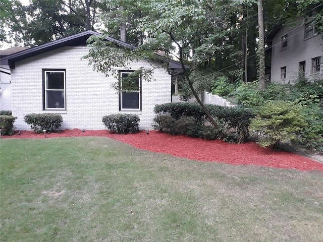 3629 Embry Cir, Atlanta, GA 30341 - view of side of home with brick siding and a yard