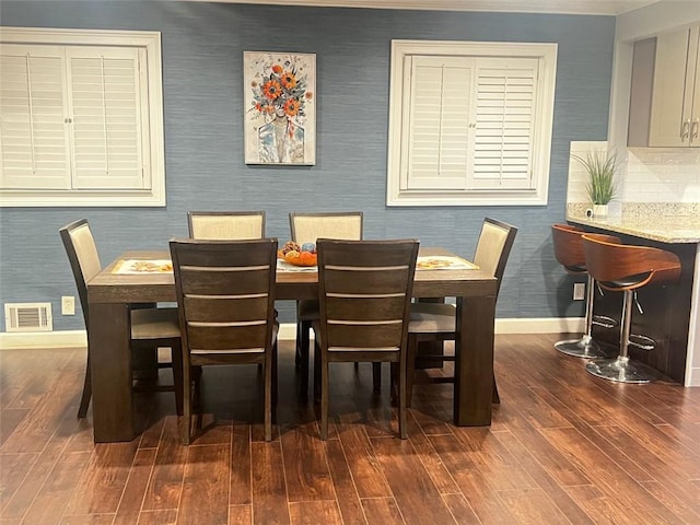 3629 Embry Cir, Atlanta, GA 30341 - dining area featuring dark wood finished floors, visible vents, baseboards, and wallpapered walls